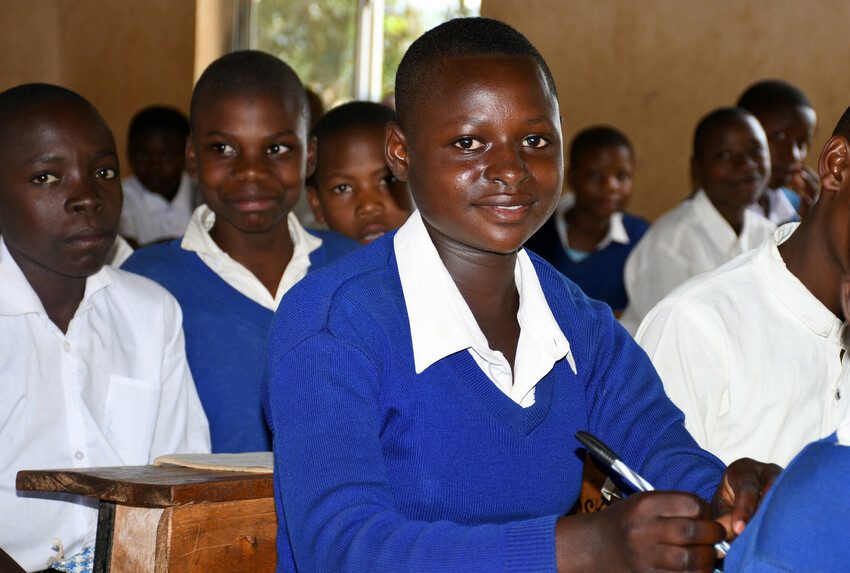 Hellen sitting at her desk in the classroom. 