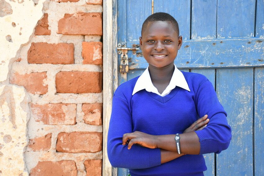 Hellen wearing her school uniform and smiling.