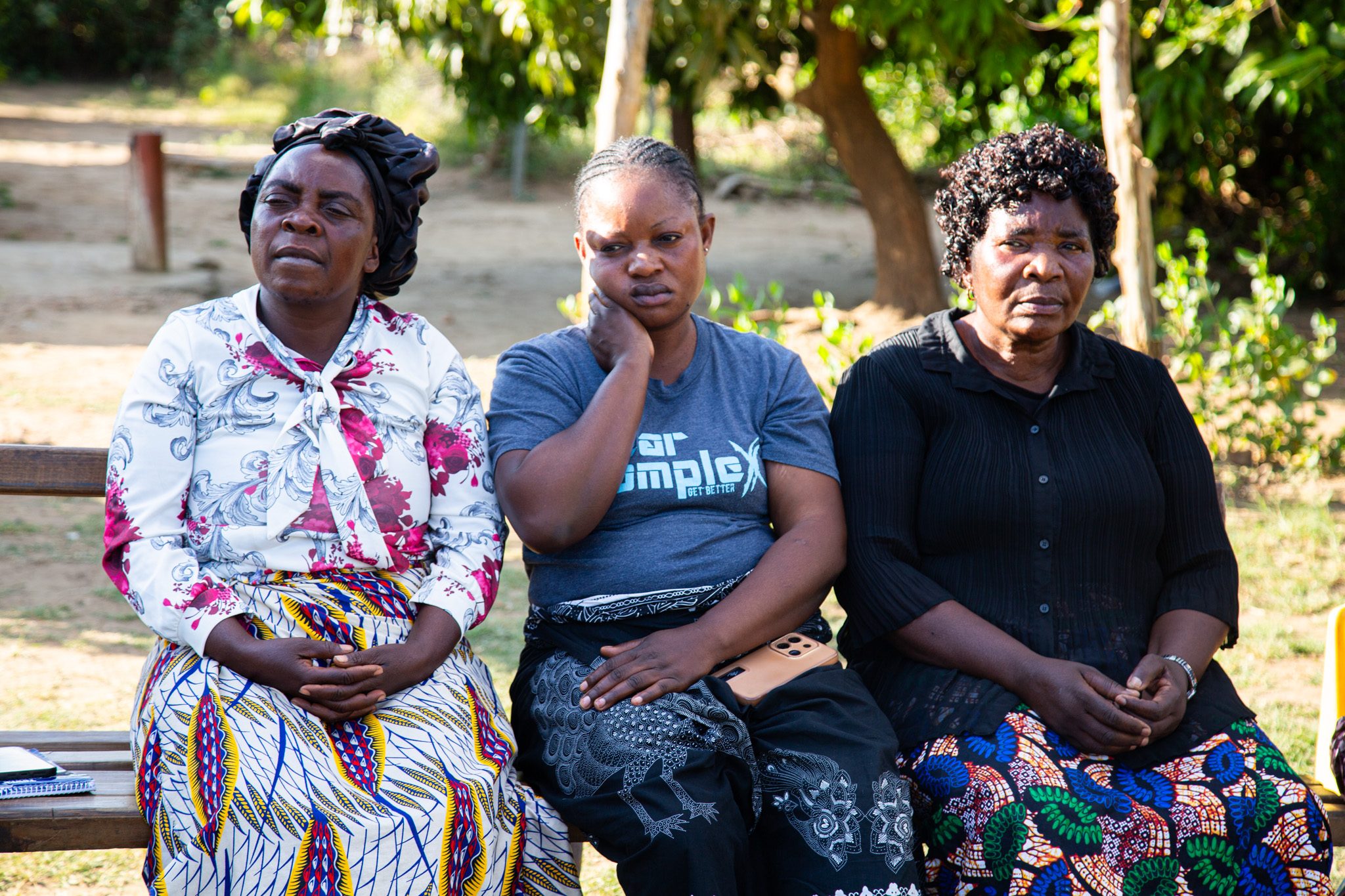 Three Alangizi women sitting together.