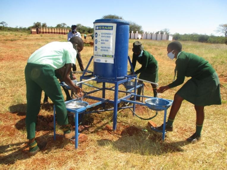 Pupils from from a secondary school washing their hands.