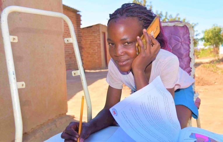 Yolanda attending an online lesson in Zimbabwe.