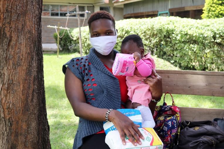 Diana, 21, receiving care package from Plan International Kenya
