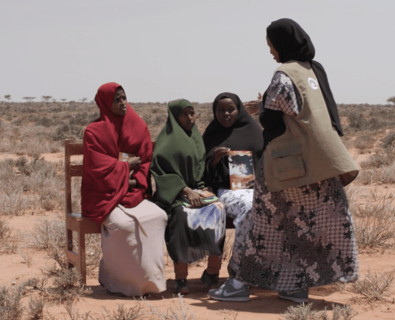 Plan International Somalia’s Communications Lead Muhiim Osman talking to girls about their experiences of the food crisis