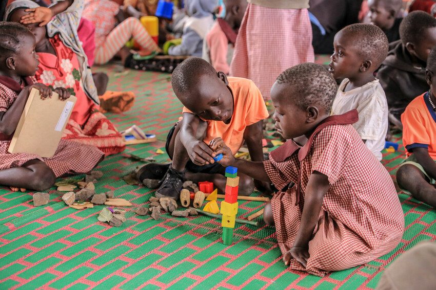 Children play with building blocks at ECD centre in refugee settlement