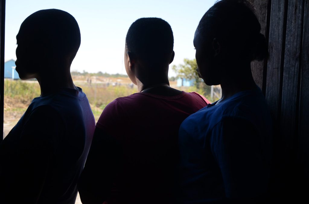Silhouette girls looking outside the door