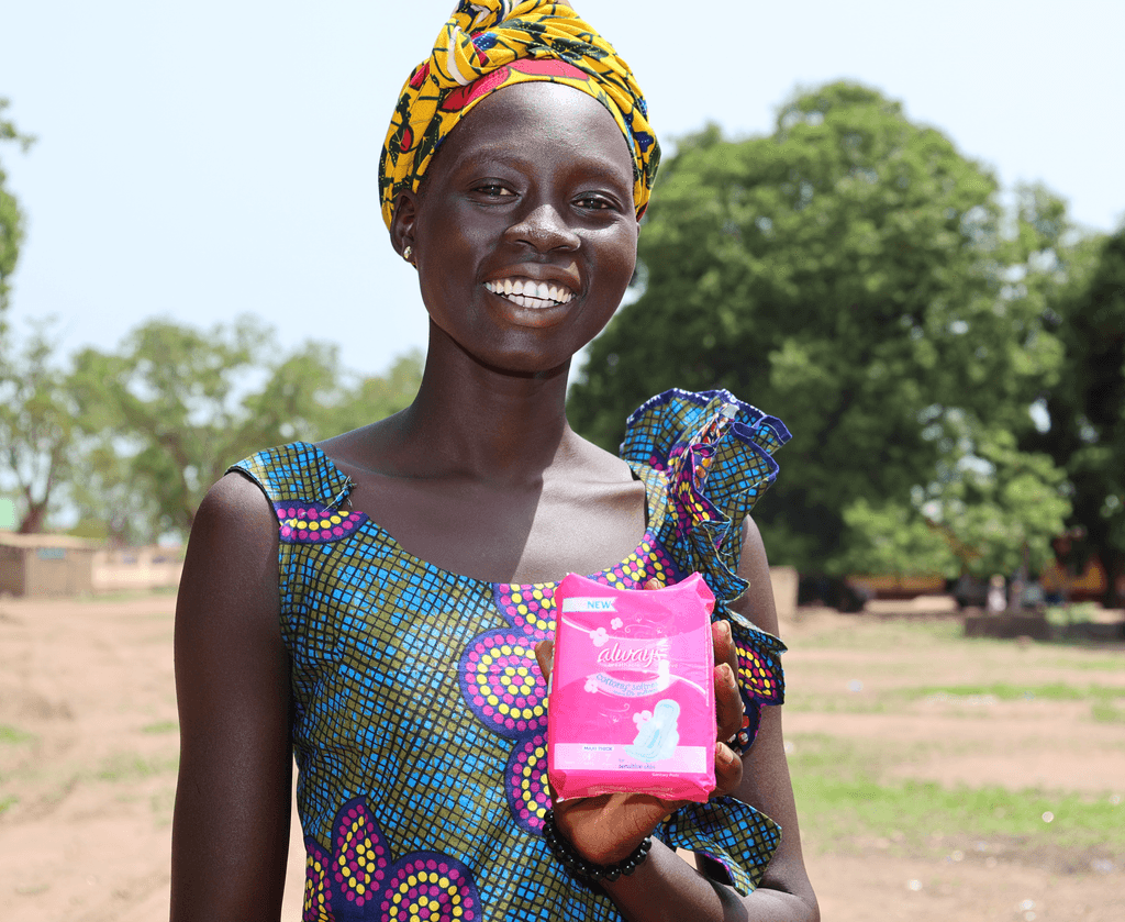 Tabitha showing the re-usable sanitary pad she got in her kit. Image credit Plan International