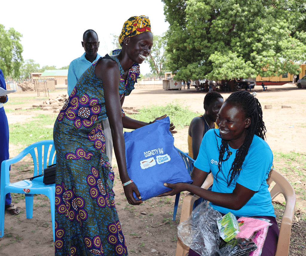 Tabitha receiving her dignity kit. Image credit Plan International