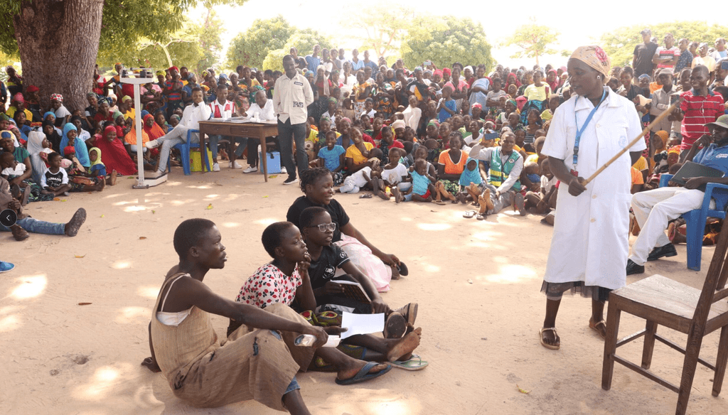 people sitting under a tree learning