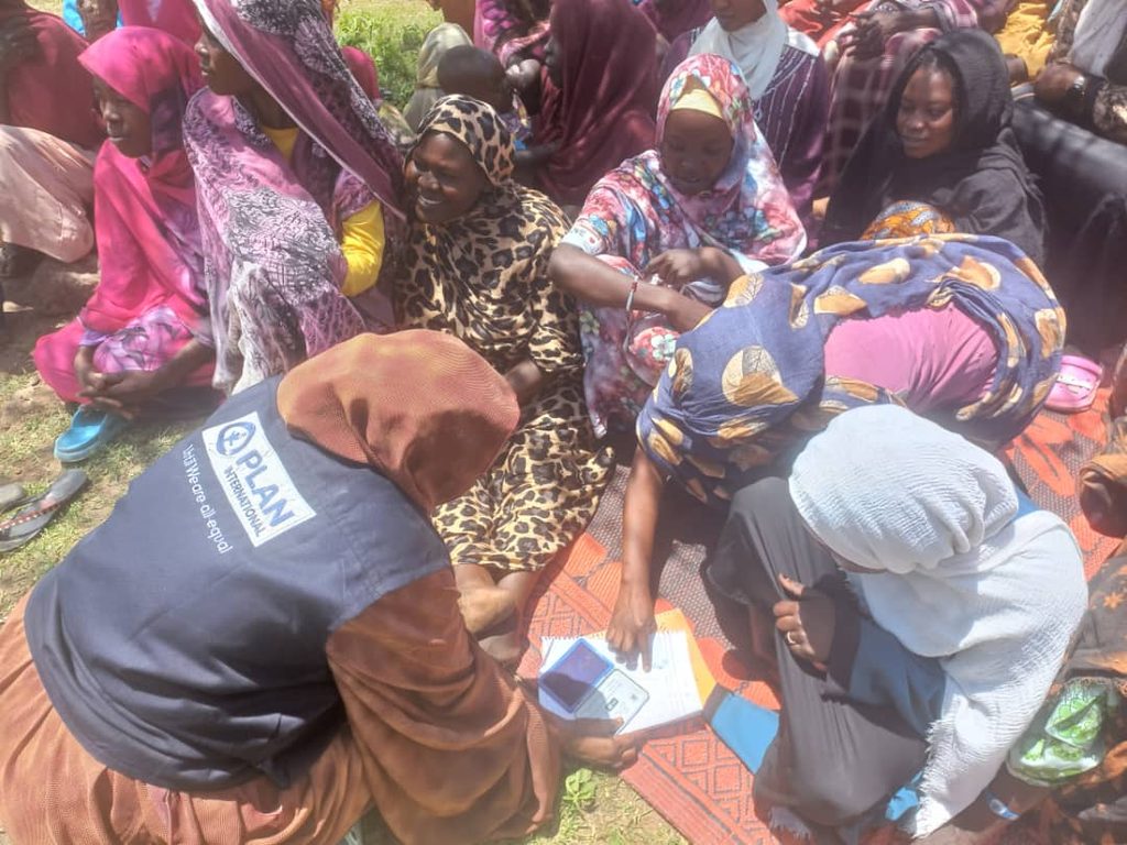 Plan International staff registering residents of Tarsin Village, Darfur