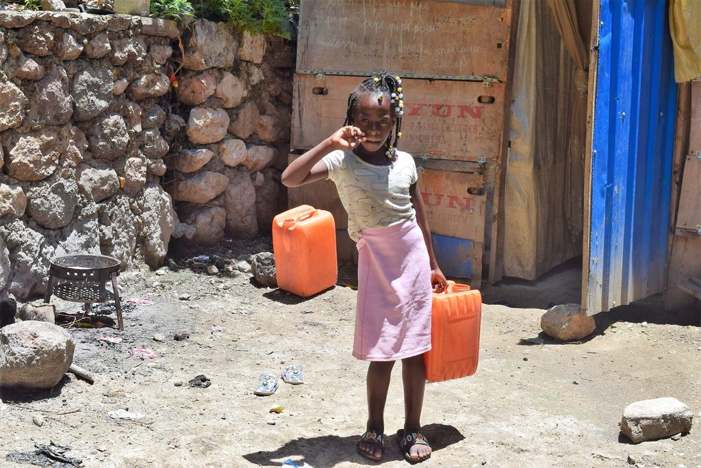 Girl carrying water in Haiti