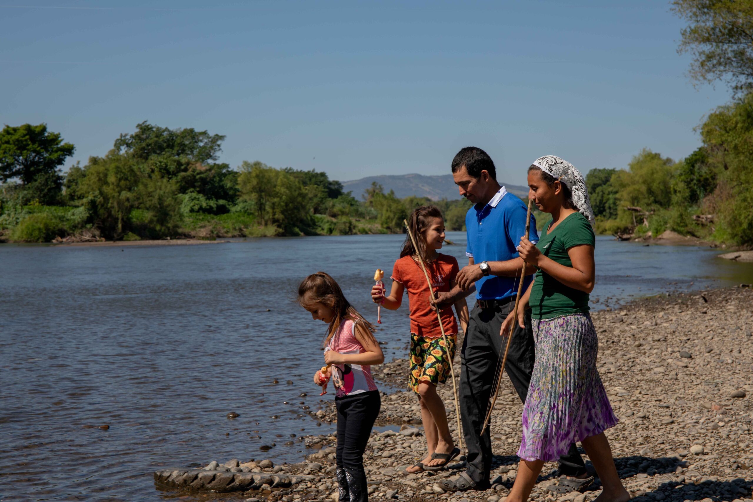 Alonso, Adelaida and their two daughters on the banks of the Lempa River, next to their house.