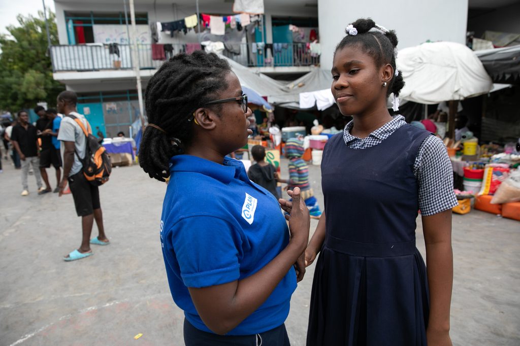 Carla, 13, talking to Plan International staff.
