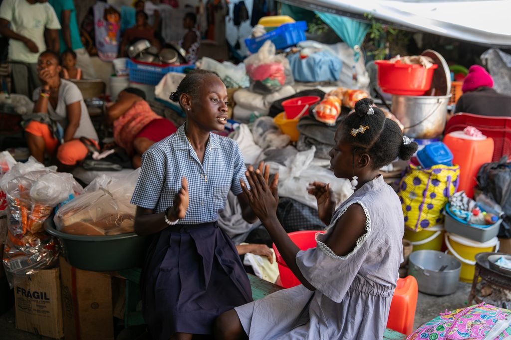 Isabelle*, 15, playing with her friend at the IDP site.