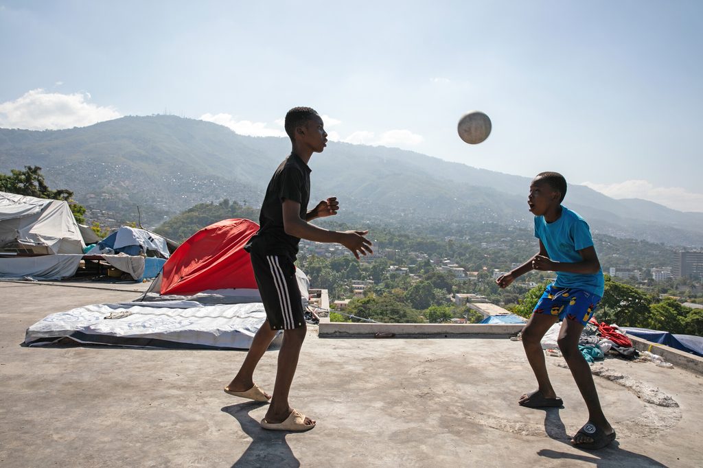 Junior*, 16, playing football on the roof of one of the IPD sites.