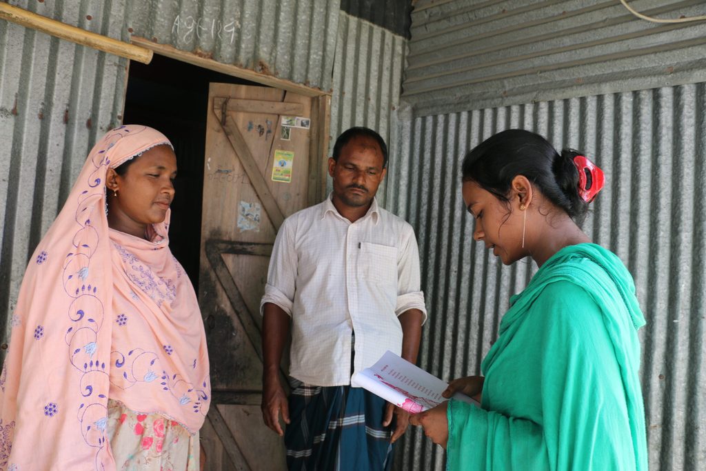 A girls reading out a poem to her parents