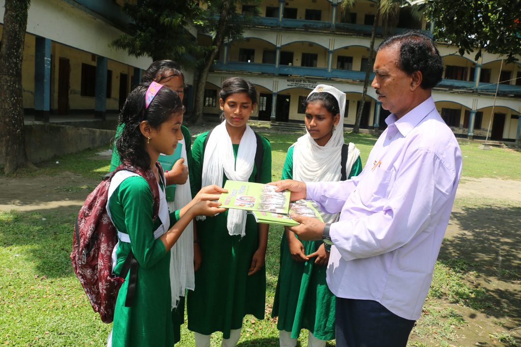 Mr. Adbus shares his poem books with students.