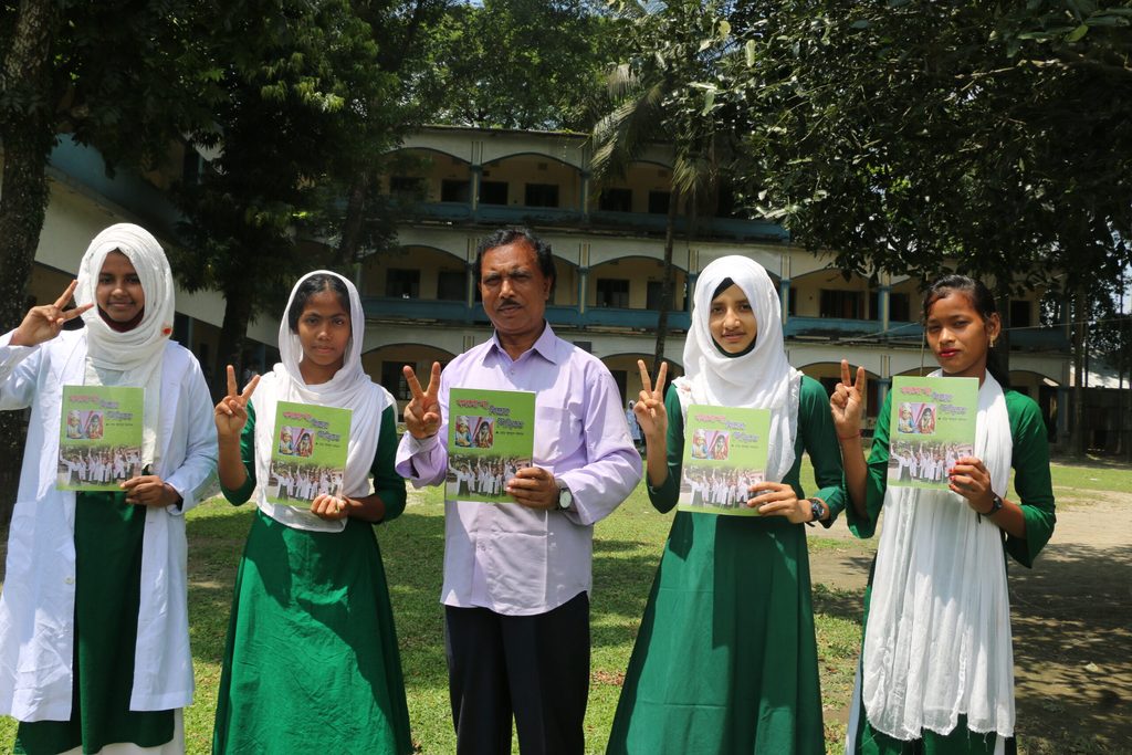 Mr. Abdus and his students with the poetry book