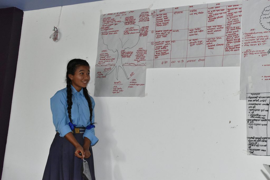 Maya presenting group work findings during the development of the education continuity plan © Plan International