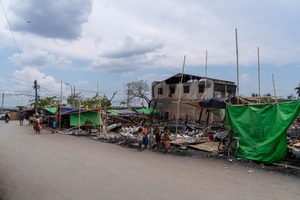 Damaged buildings along a road.
