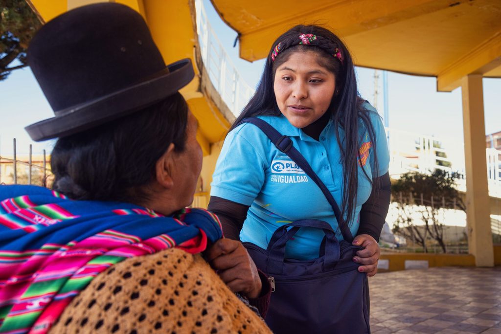 Camila talking with a woman from her community