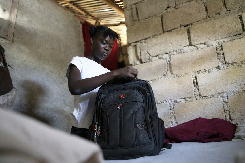 Dialissa, 15, prepares her bag ready for school 