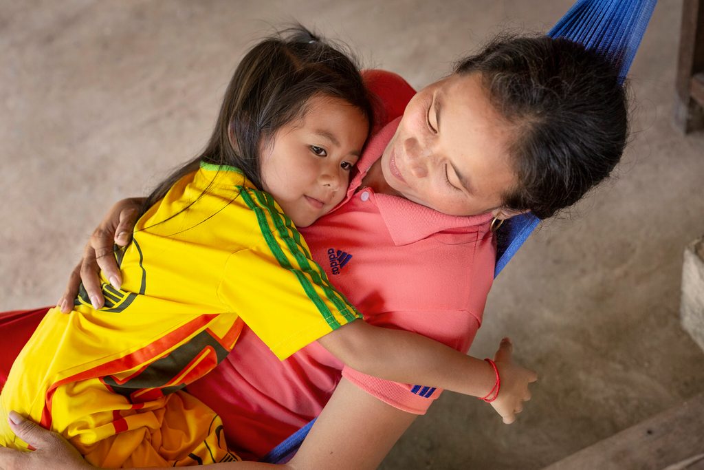 A mother and child share a hug in Cambodia