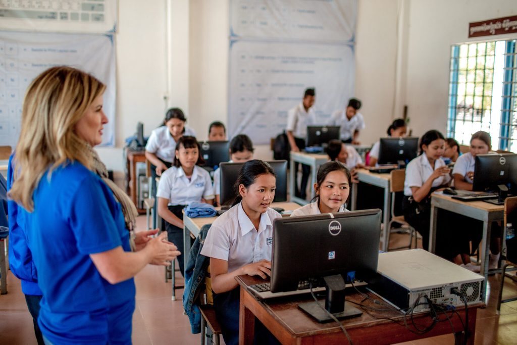 Girls learning on computers at school in Cambodia