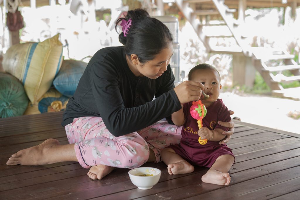 A mother feeding her child in Cambodia