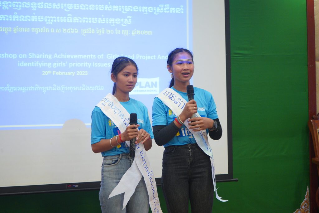 Girls speaking into microphones at a Plan International Cambodia event