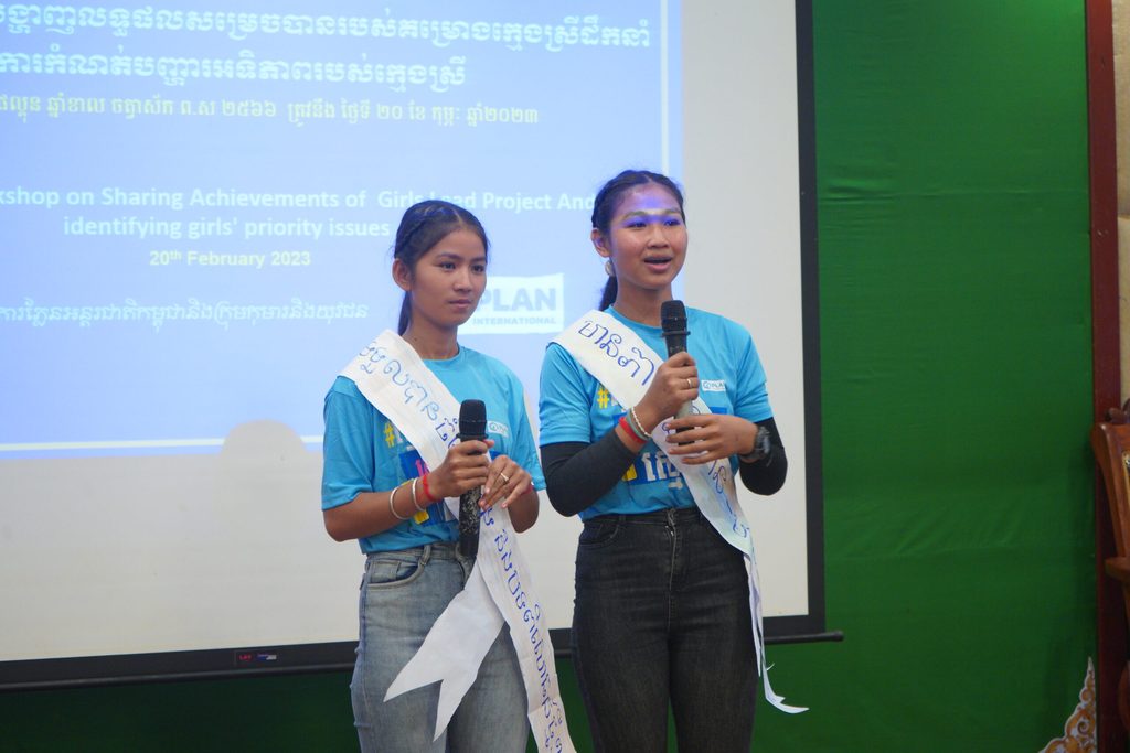 Girls speaking into microphones at a Plan International Cambodia event