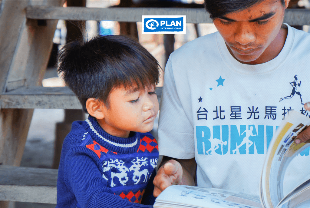 Pen reading to his son