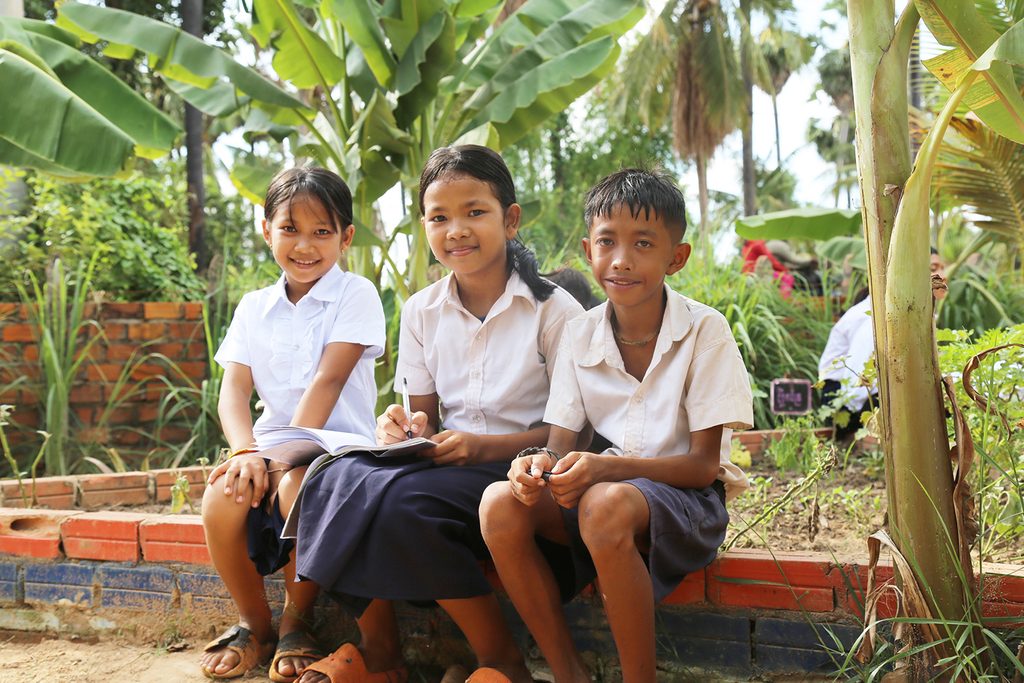 Students enjoy outdoor learning at school garden.