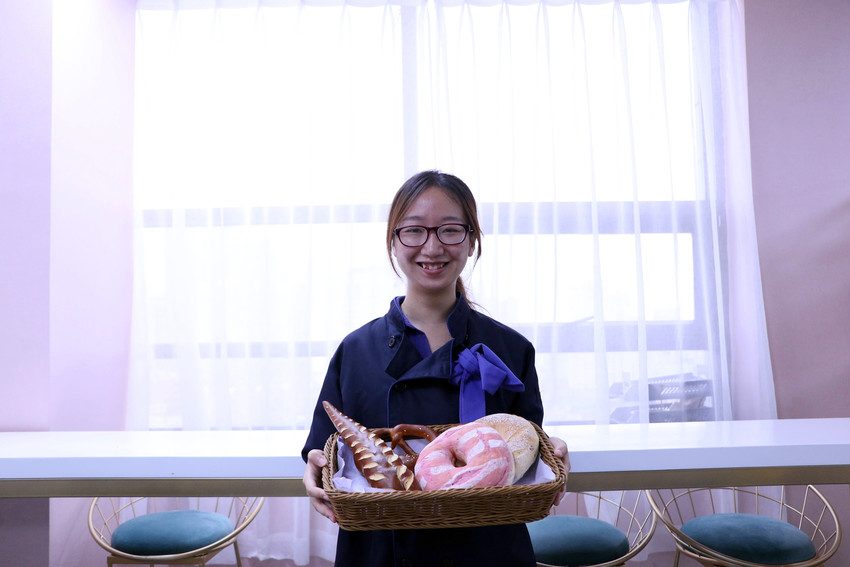 Liu presents some of her wares made during her bakery lessons