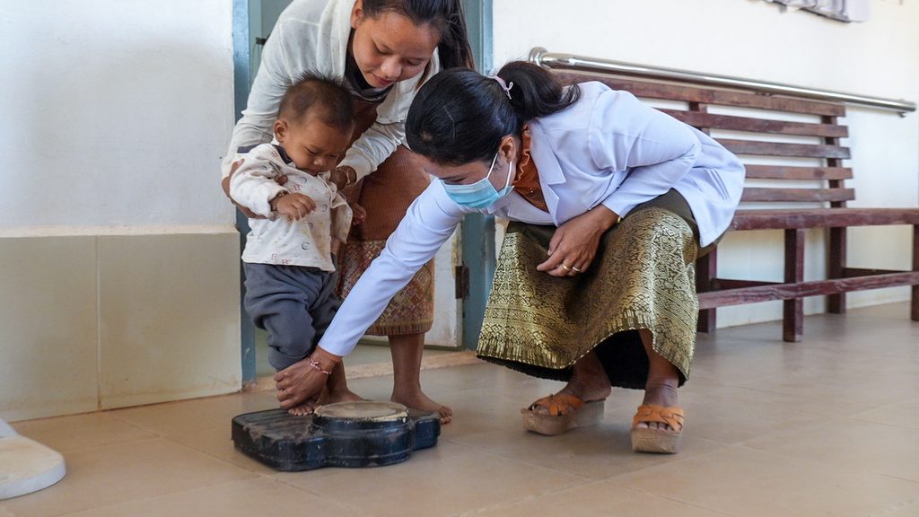 image for sub-heading Doctor Lattana weighs Khamkeo’s son to monitor his growth and ensure he is developing at a healthy rate.