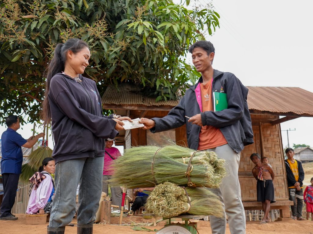 image of Serth purchases flowers of broom grass Serth purchasing flowers from villagers.