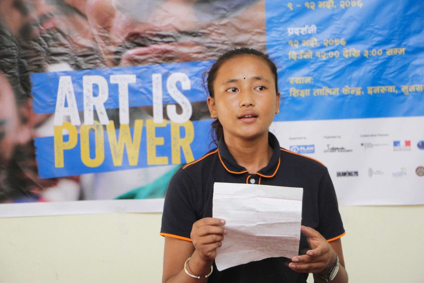 Girl reads poem at Art is Power workshop in Nepal