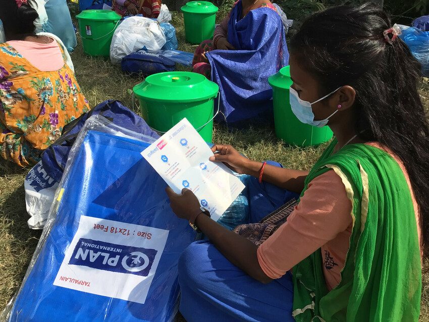 Families receive relief aid from Plan International in Nepal