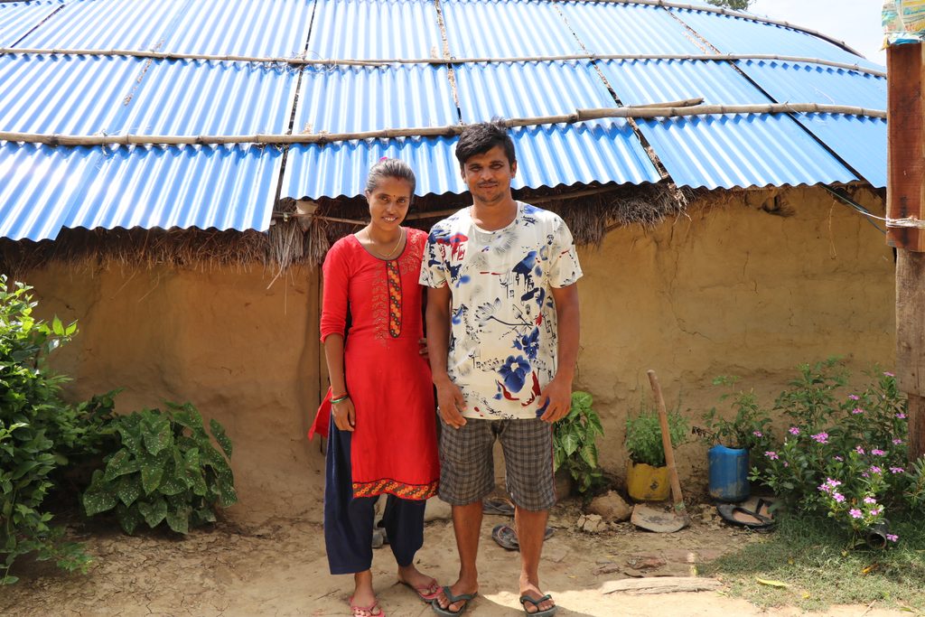 Melina and Suman in front of their house