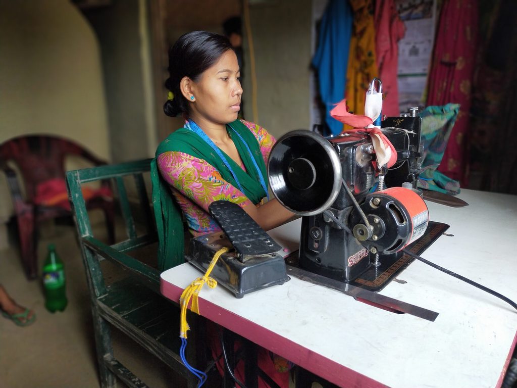 Sita cleaning her sewing machine