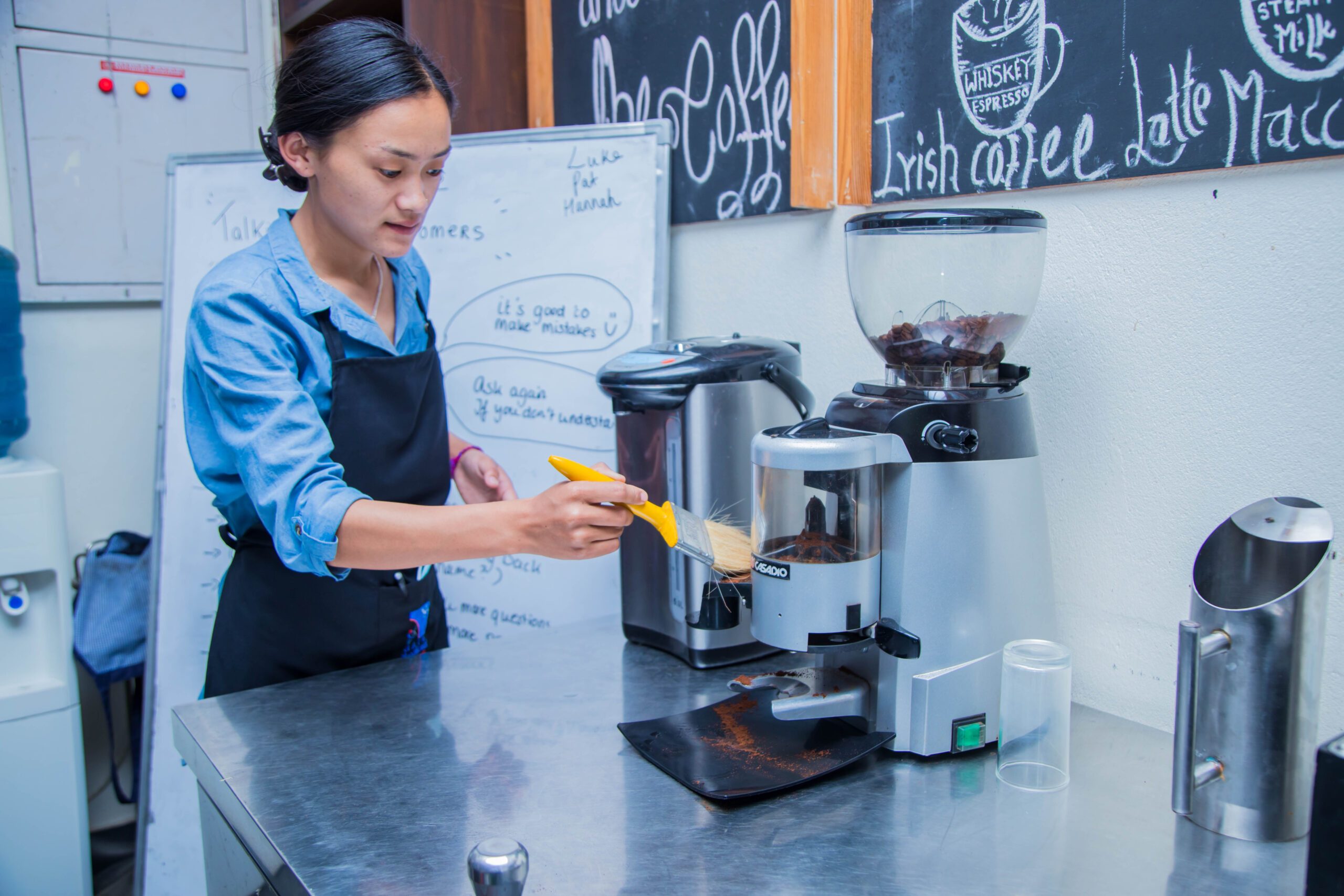 A young woman training to be a barista