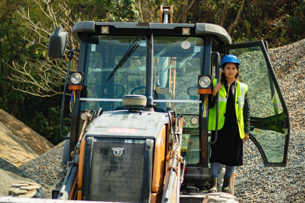 Sushma working as an excavator operator