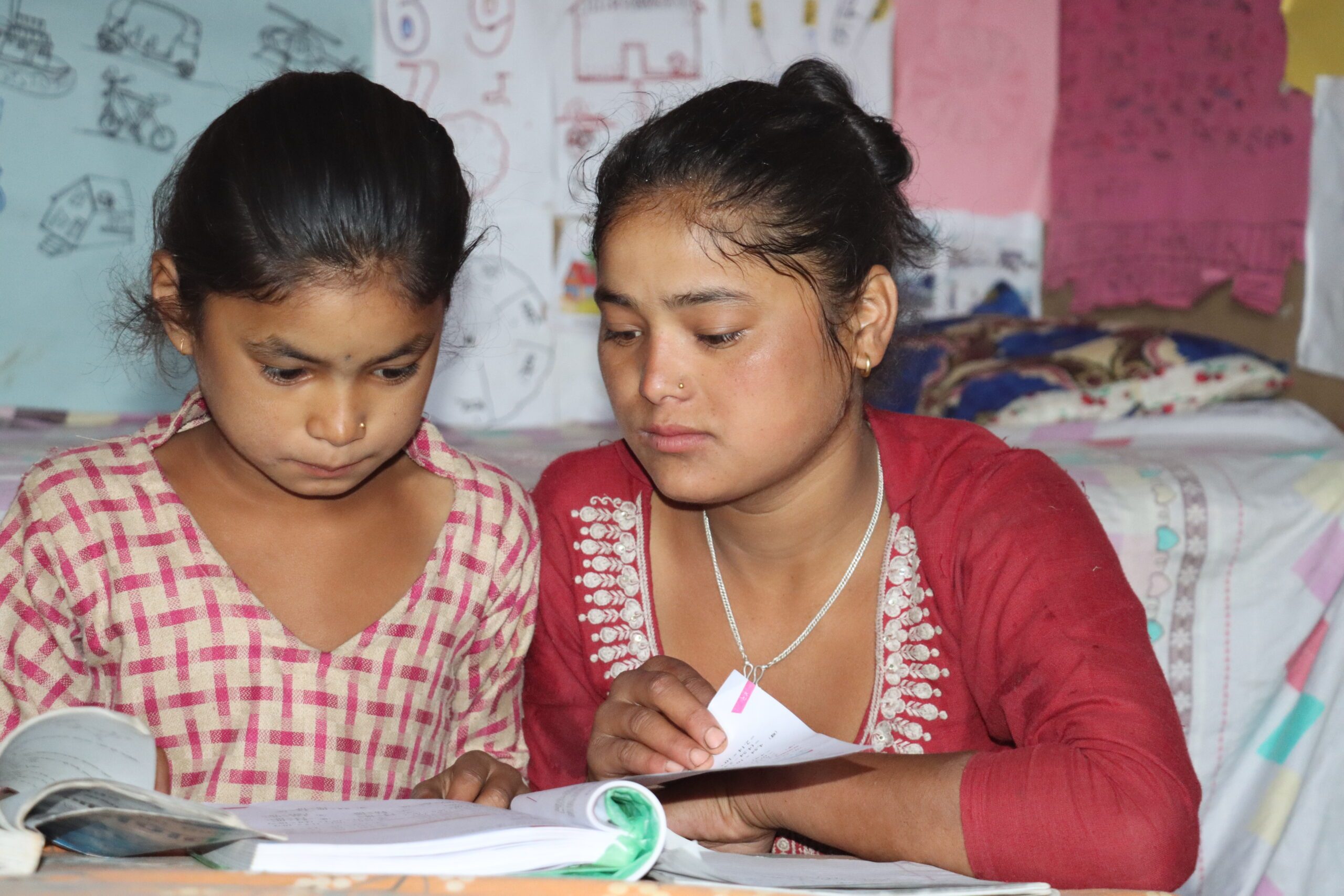 Pratikshya (left) reading with her elder sister