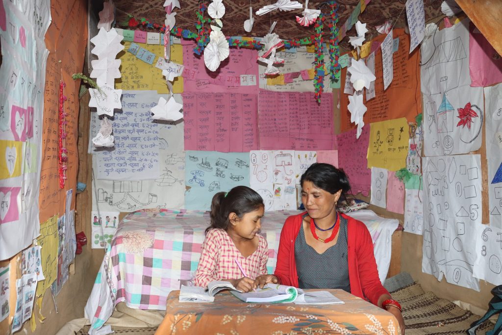 Pratikshya (left) doing homework with her mother, Chana