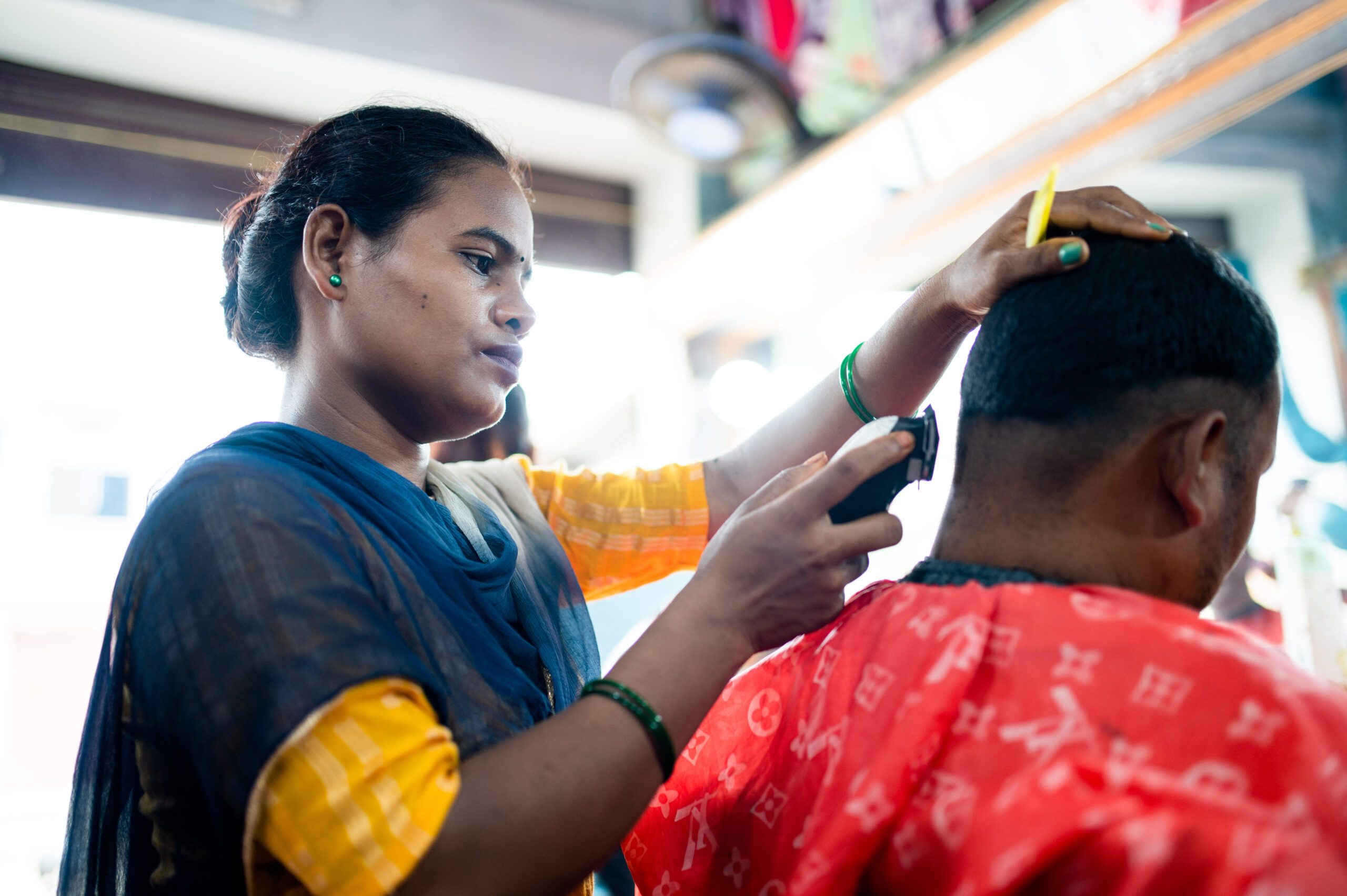 Rampati cutting a mans hair. 