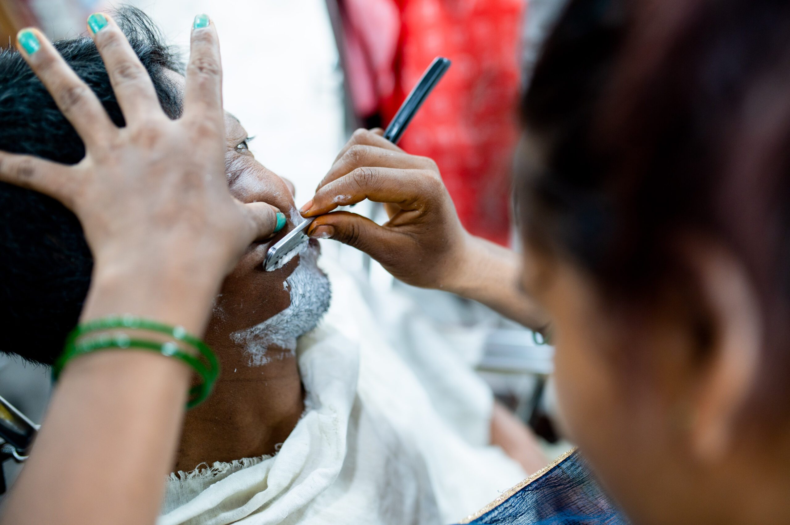 Rampati shaving a customer.