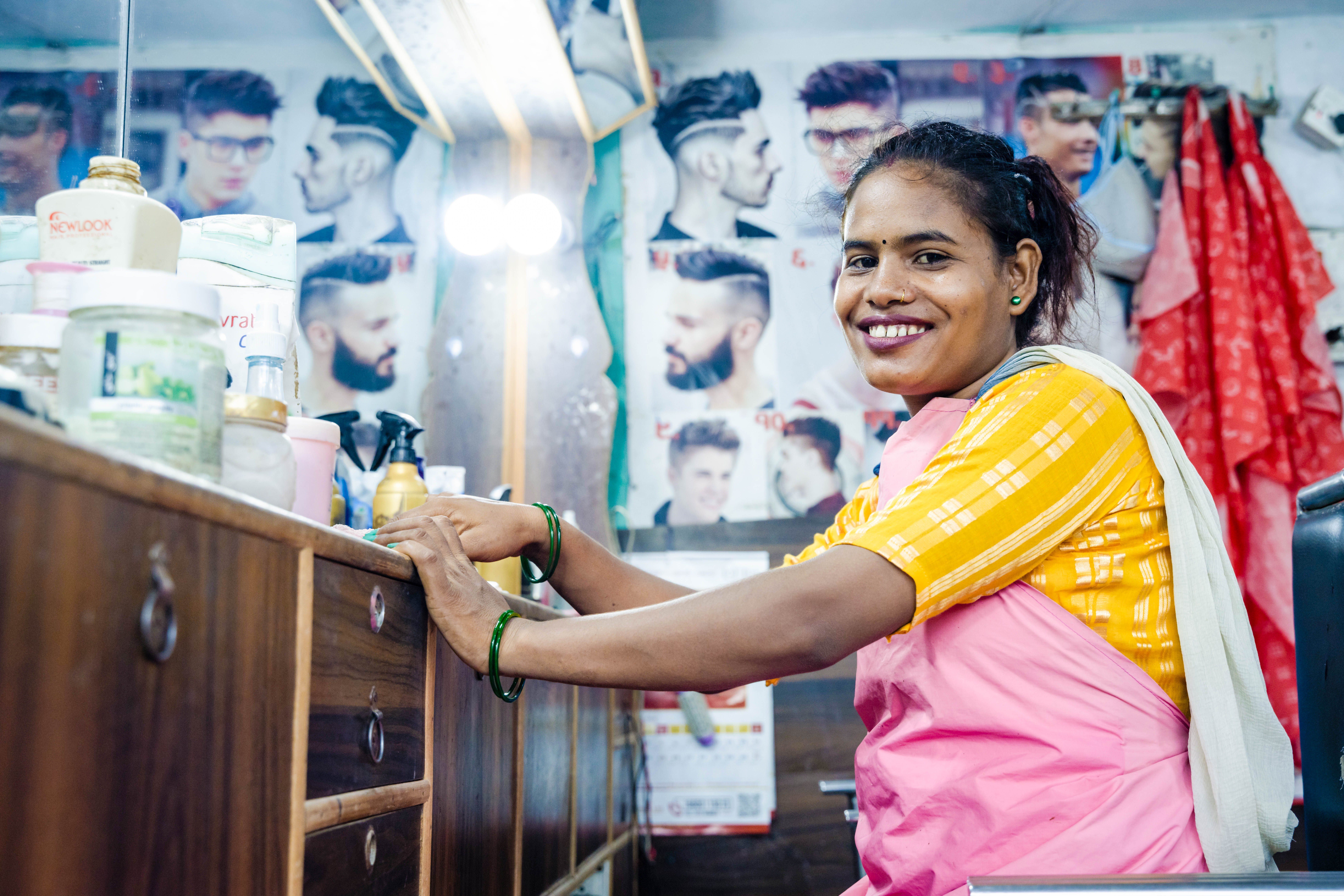 Rampati smiling at her hairdressing station. 