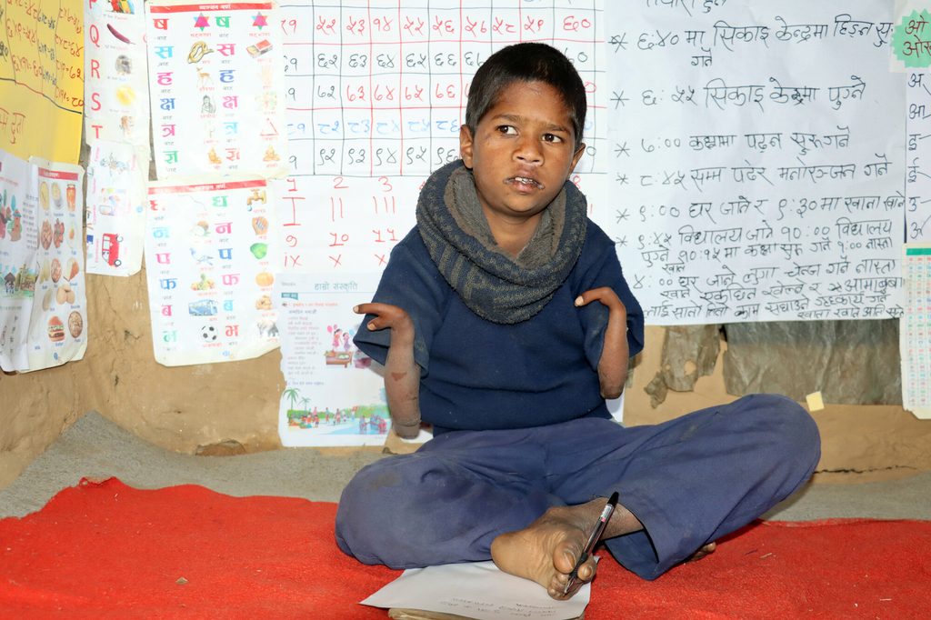 Bimal in his classroom decorated with reading materials. 