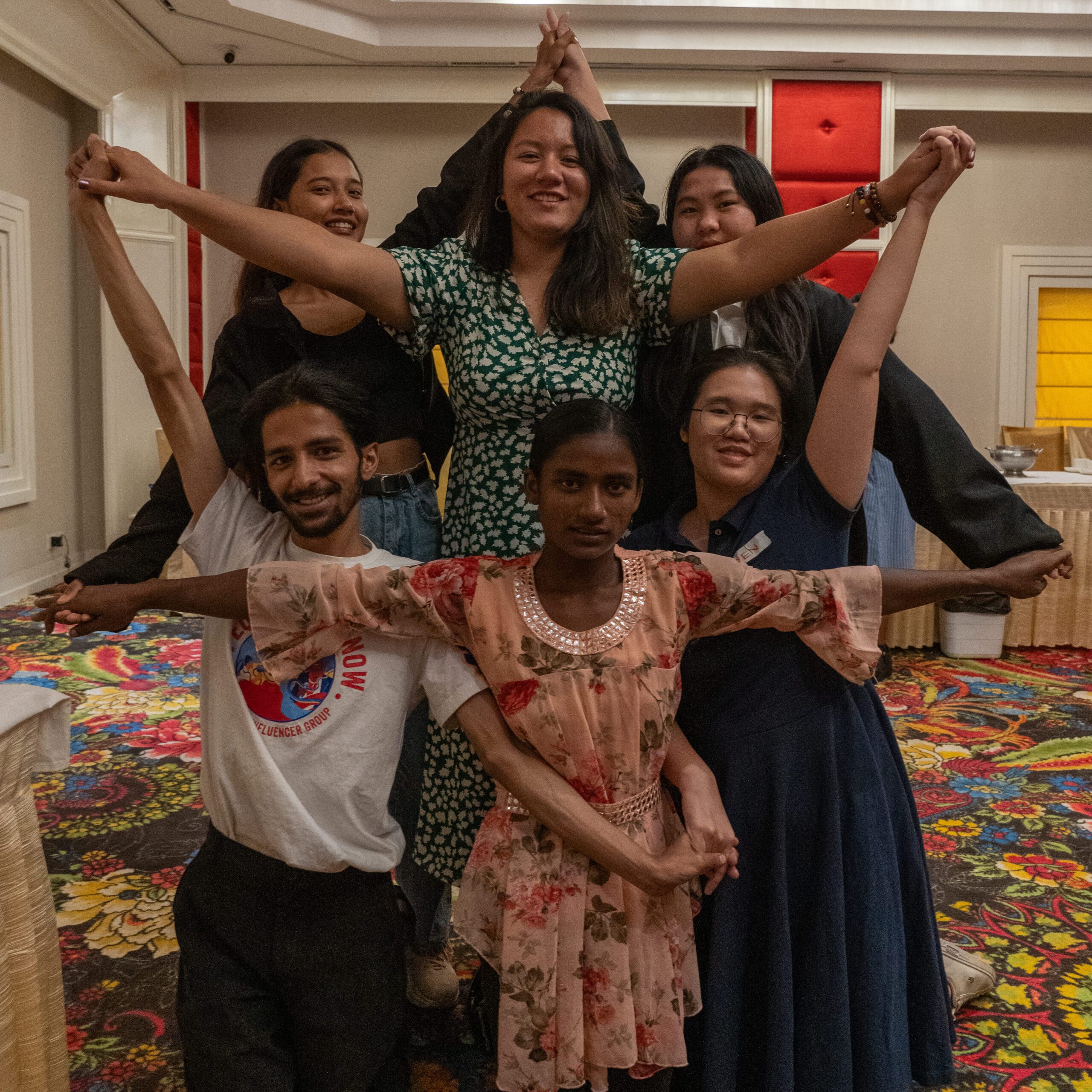 Bipasa and other programme participants create a star with their arms. 