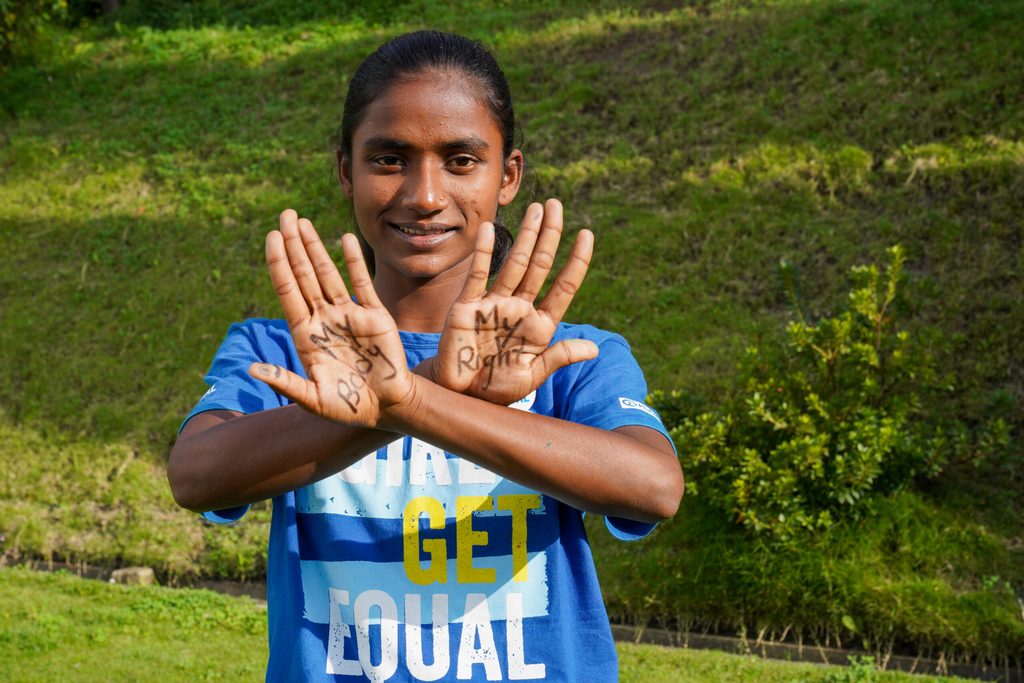 Bipasa holds up her hands with 'My Body, My Right' written across them.