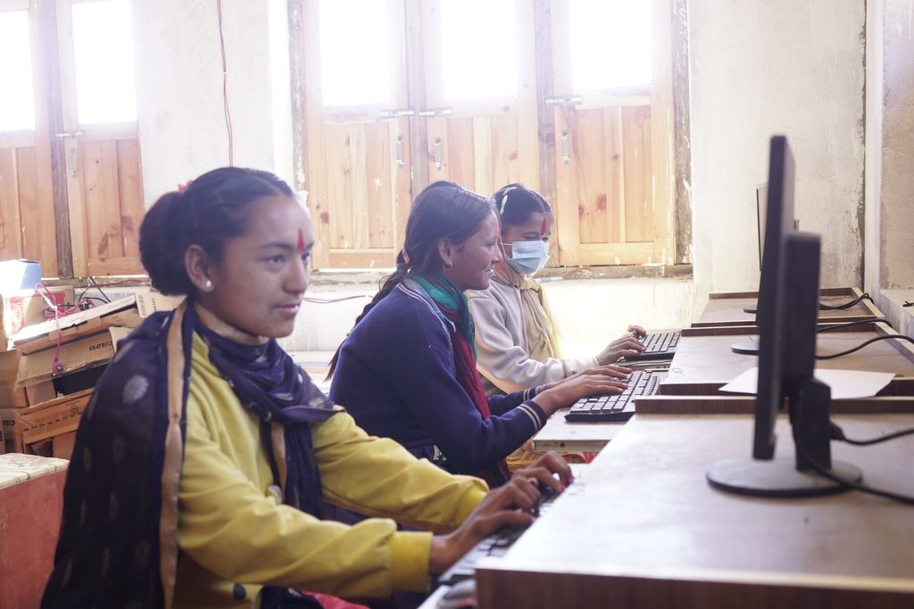 Three girls using computers.